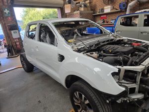 Ford Ranger XLT White Smash repair dents PDR Dah Cheong Sydney work in progress paint